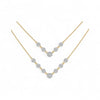 Gold necklace with diamond-like stones on a white background