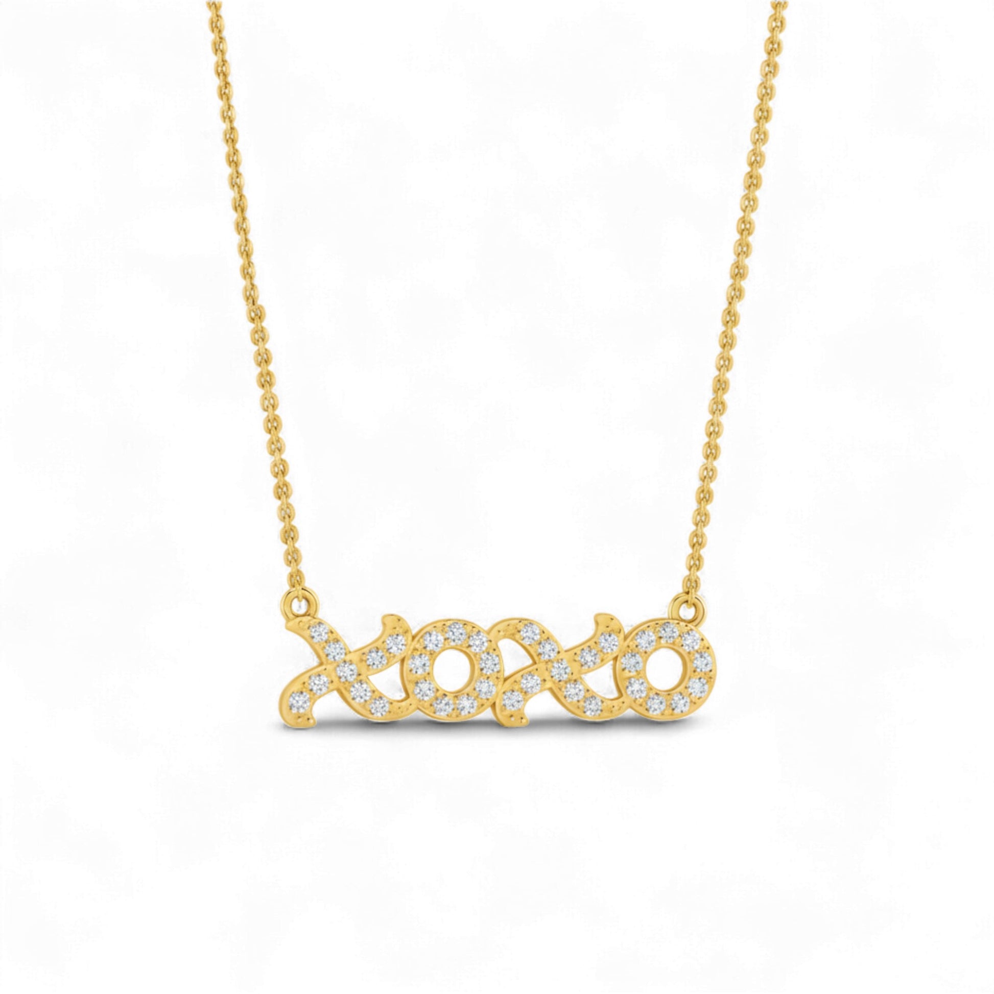 Gold necklace with a diamond-encrusted pendant on a white background