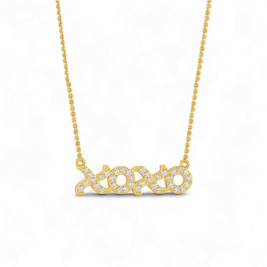 Gold necklace with a diamond-encrusted pendant on a white background