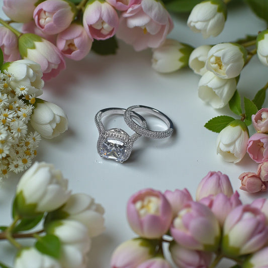 Silver ring with diamond on a bed of pink and white flowers