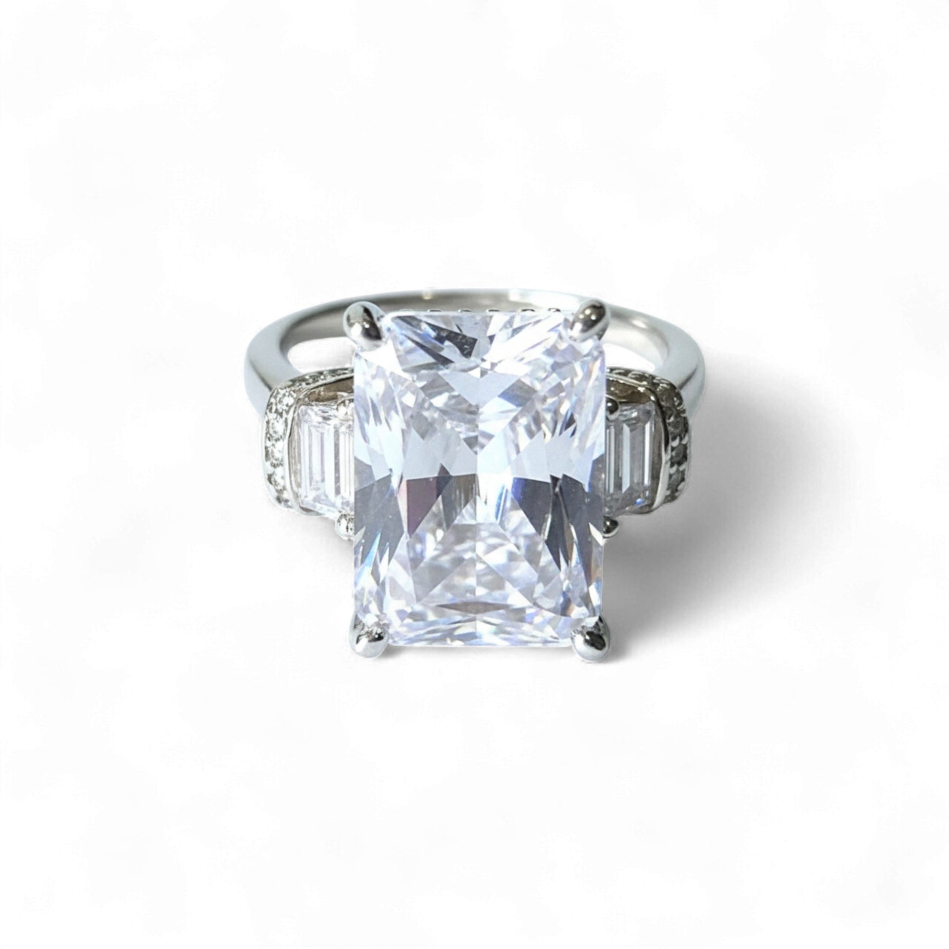 Diamond ring with a large central gemstone on a white background