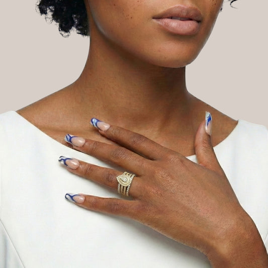 Woman wearing a gold ring with a white background