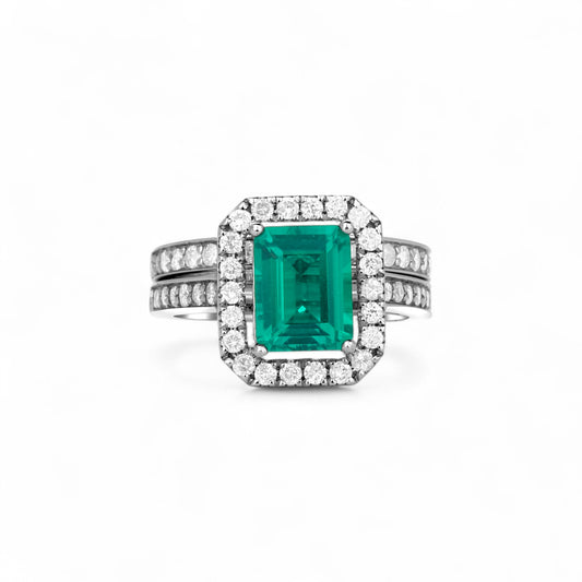 Ring with emerald and diamonds on a white background