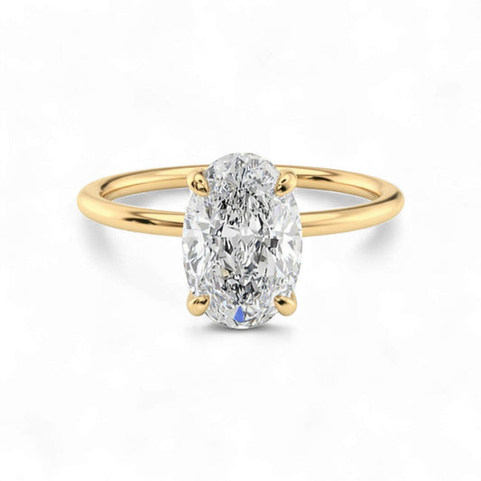 Gold ring with a large diamond on a white background