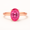 Rose gold ring with a pink gemstone on a white background