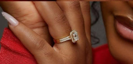 Close-up of a hand wearing a diamond ring with a blurred background