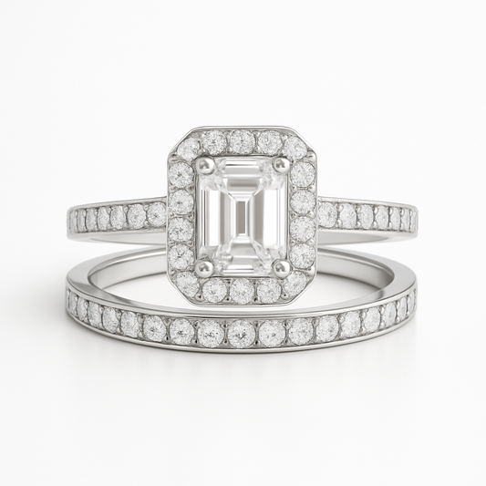 Diamond ring with emerald-cut center stone on a white background