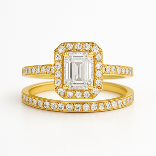 Gold ring with emerald-cut diamond and diamond-studded band on a white background