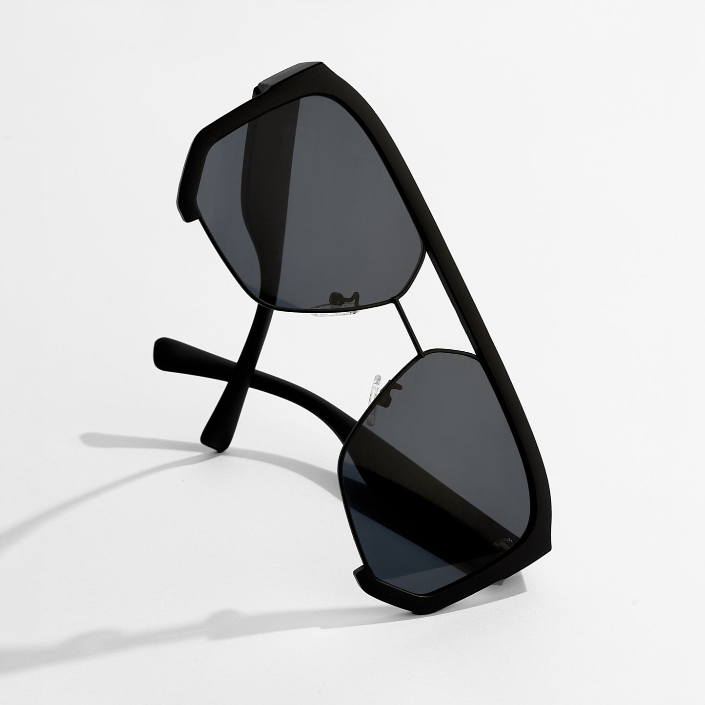 Black sunglasses with reflective lenses on a white background