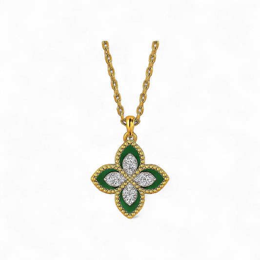 Gold necklace with a green and white floral pendant on a white background