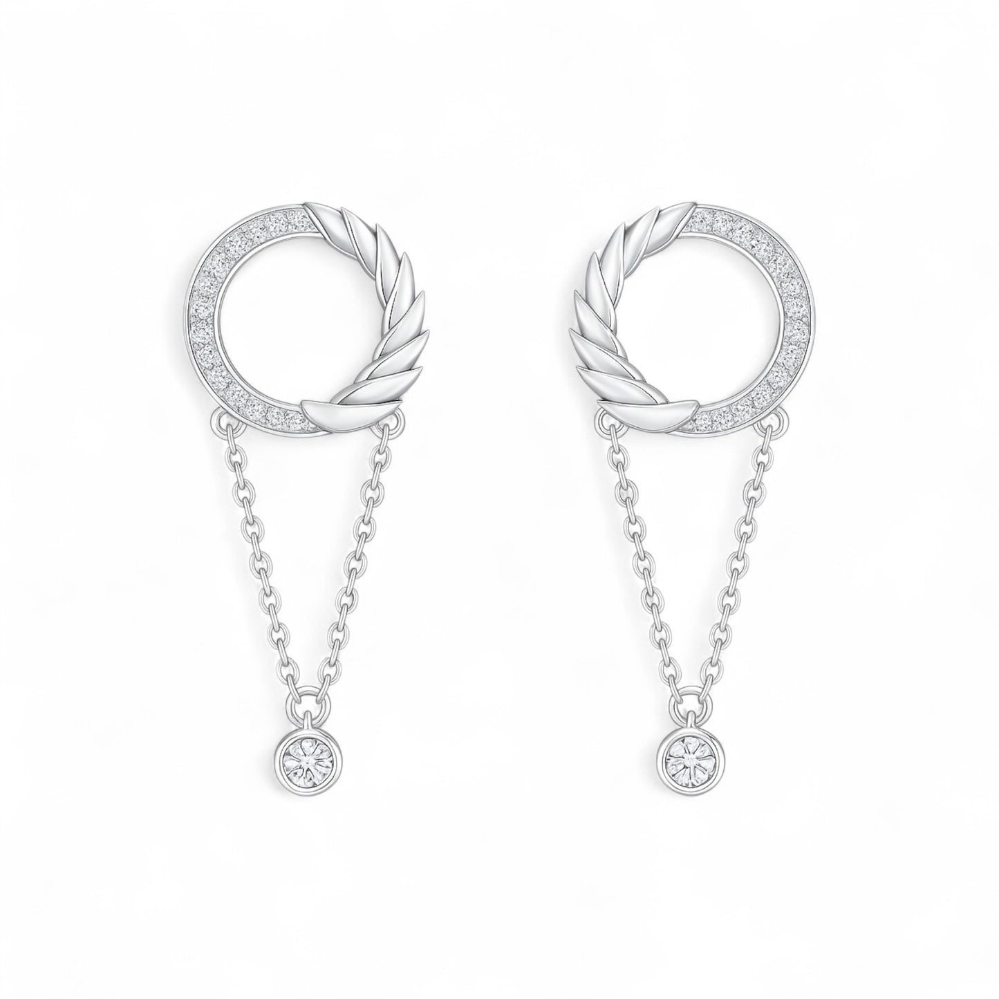 Pair of silver earrings with circular designs and chain details on a white background