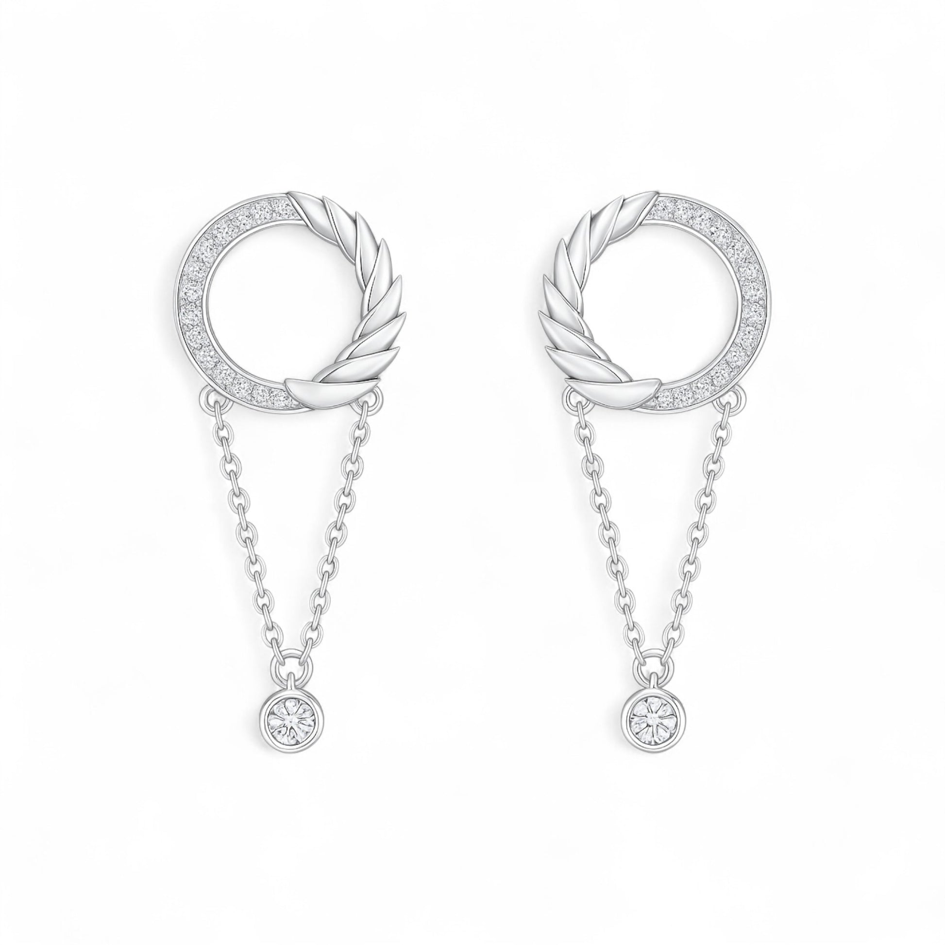 Pair of silver earrings with circular designs and chain details on a white background