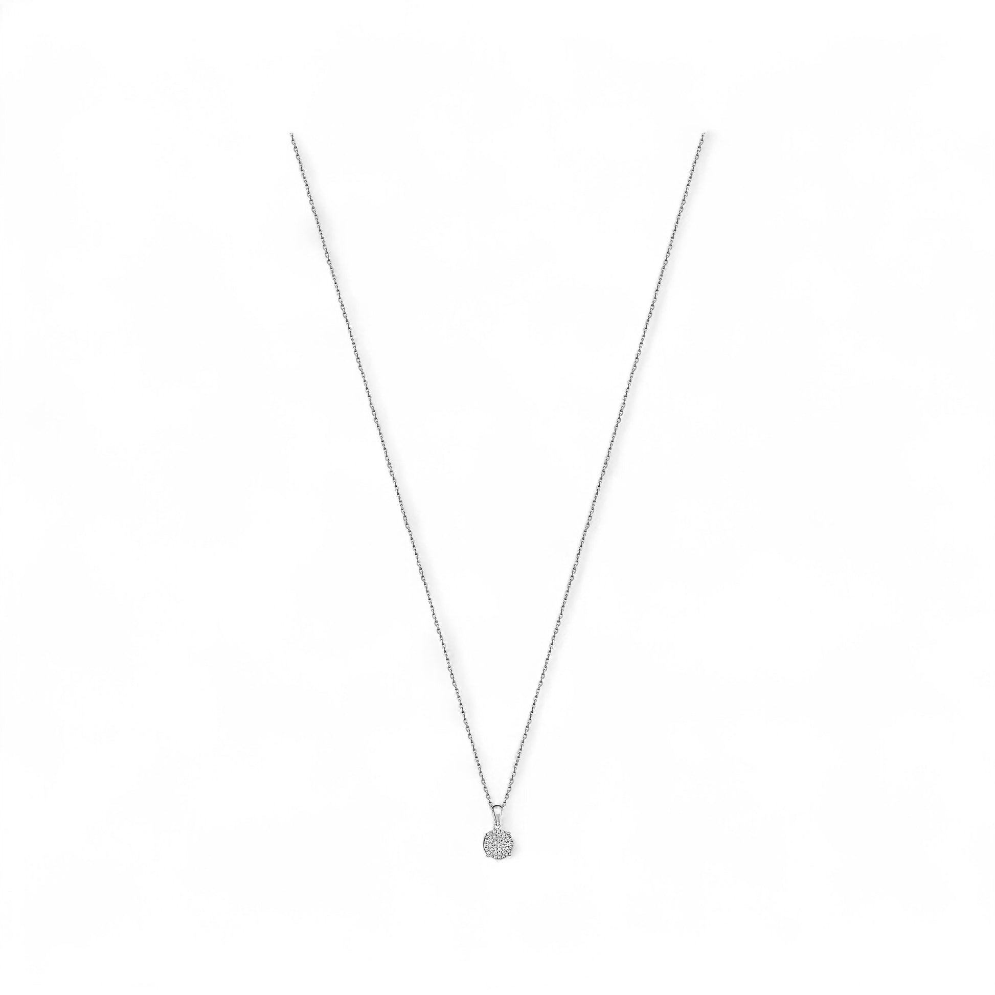 Silver necklace with a small round pendant on a white background