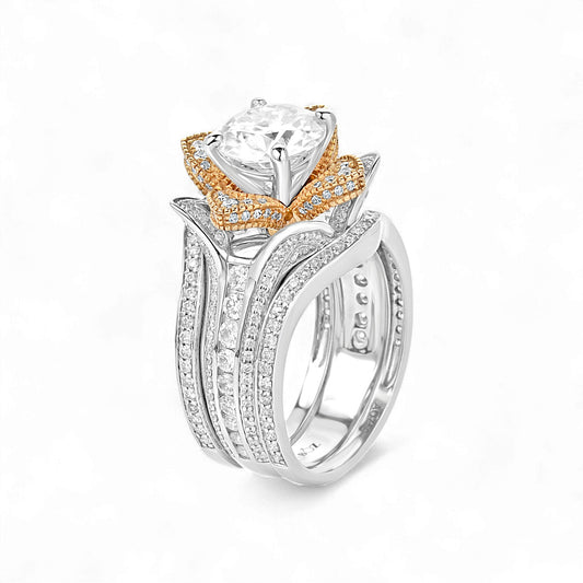 Two-tone ring with a large central gemstone on a white background
