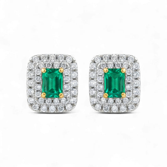 Pair of emerald cut gemstone earrings with diamond accents on a white background