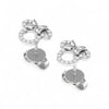 Silver bow-shaped earrings with clear gemstones on a white background