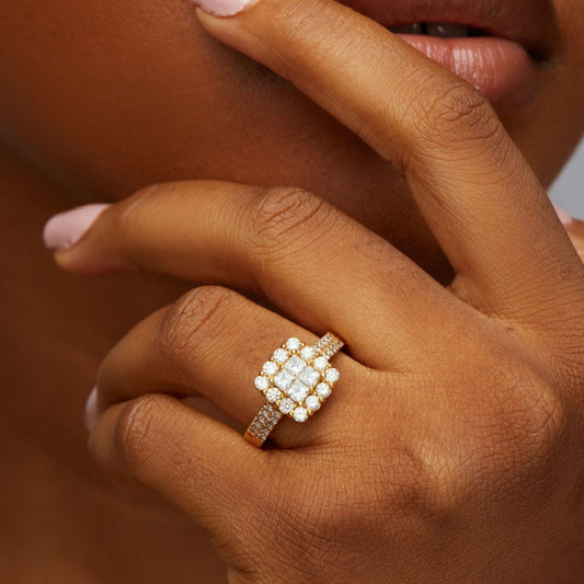Close-up of a hand wearing a diamond ring with a blurred background