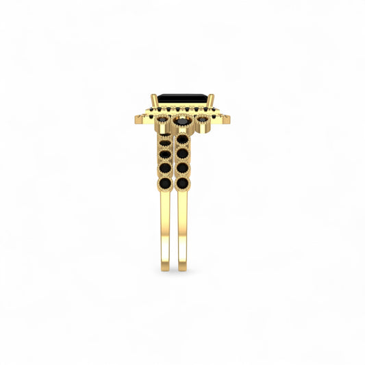 Gold ring with black gemstones on a white background