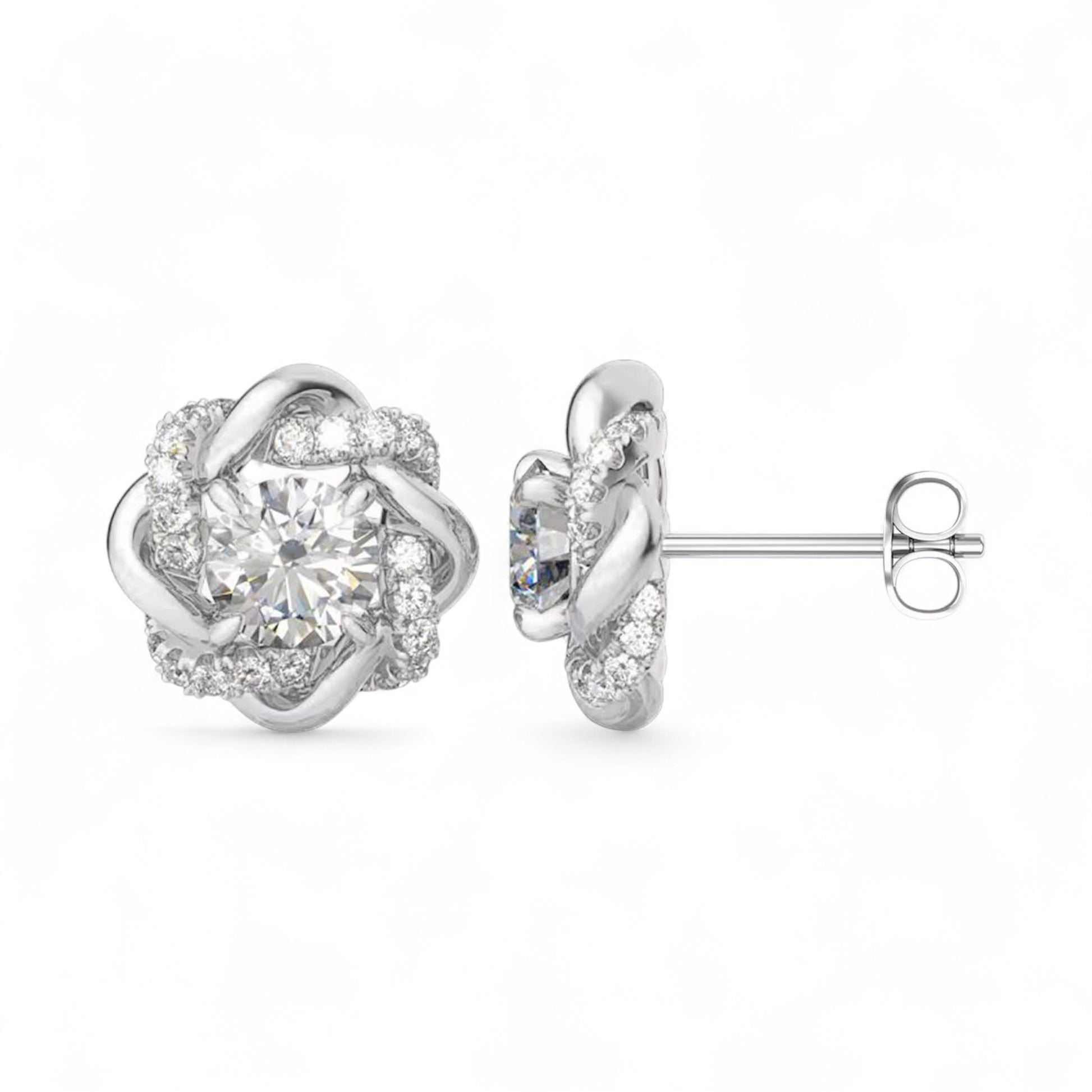 Silver earrings with a floral design and clear gemstones on a white background