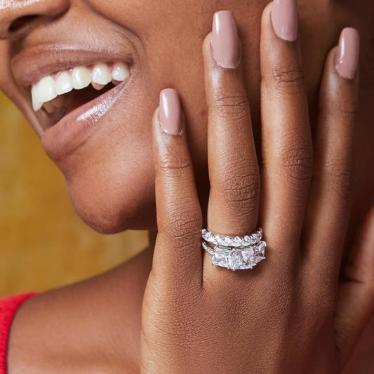 Woman wearing a diamond ring on her hand with a blurred background