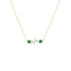 Gold necklace with emerald green gemstones on a white background