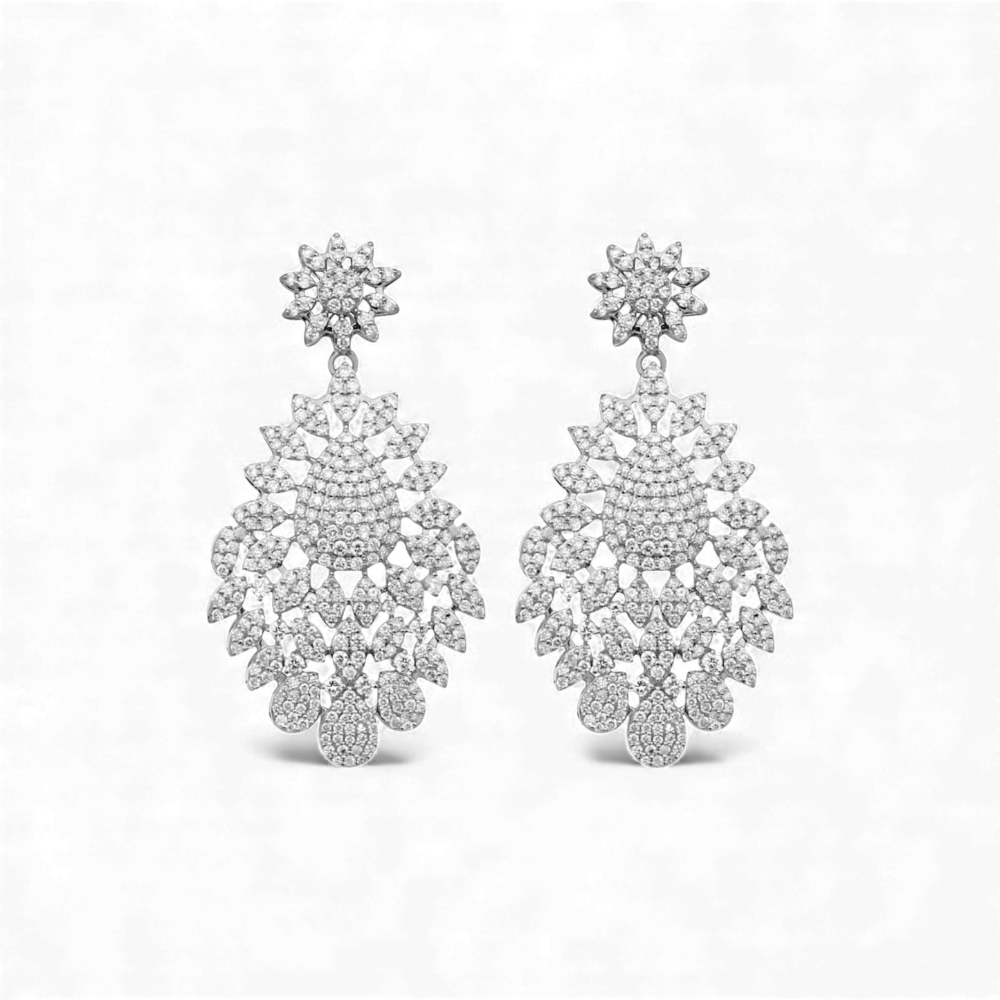 Pair of silver chandelier earrings on a white background