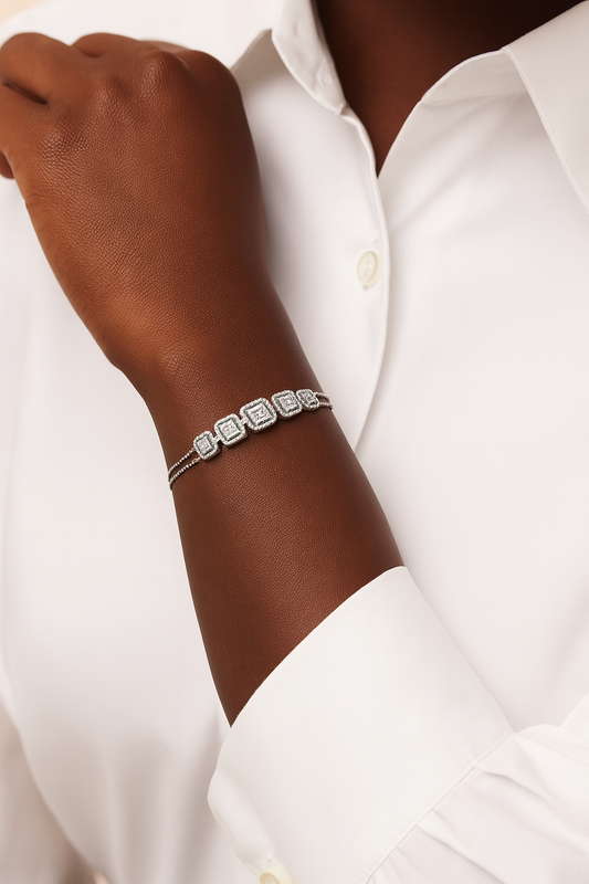 Silver bracelet on a wrist with a white shirt background