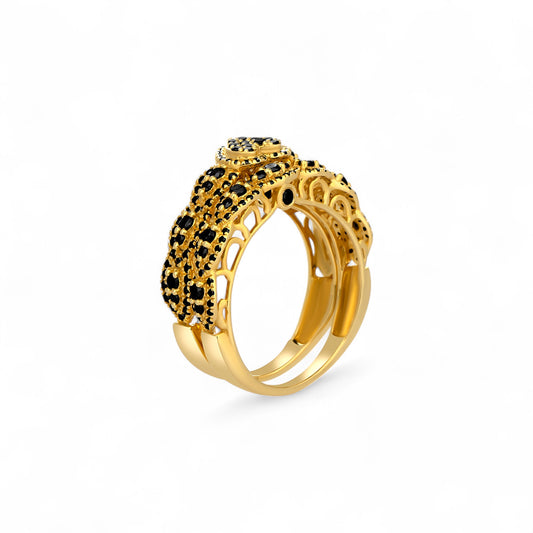 Gold ring with black gemstones on a white background