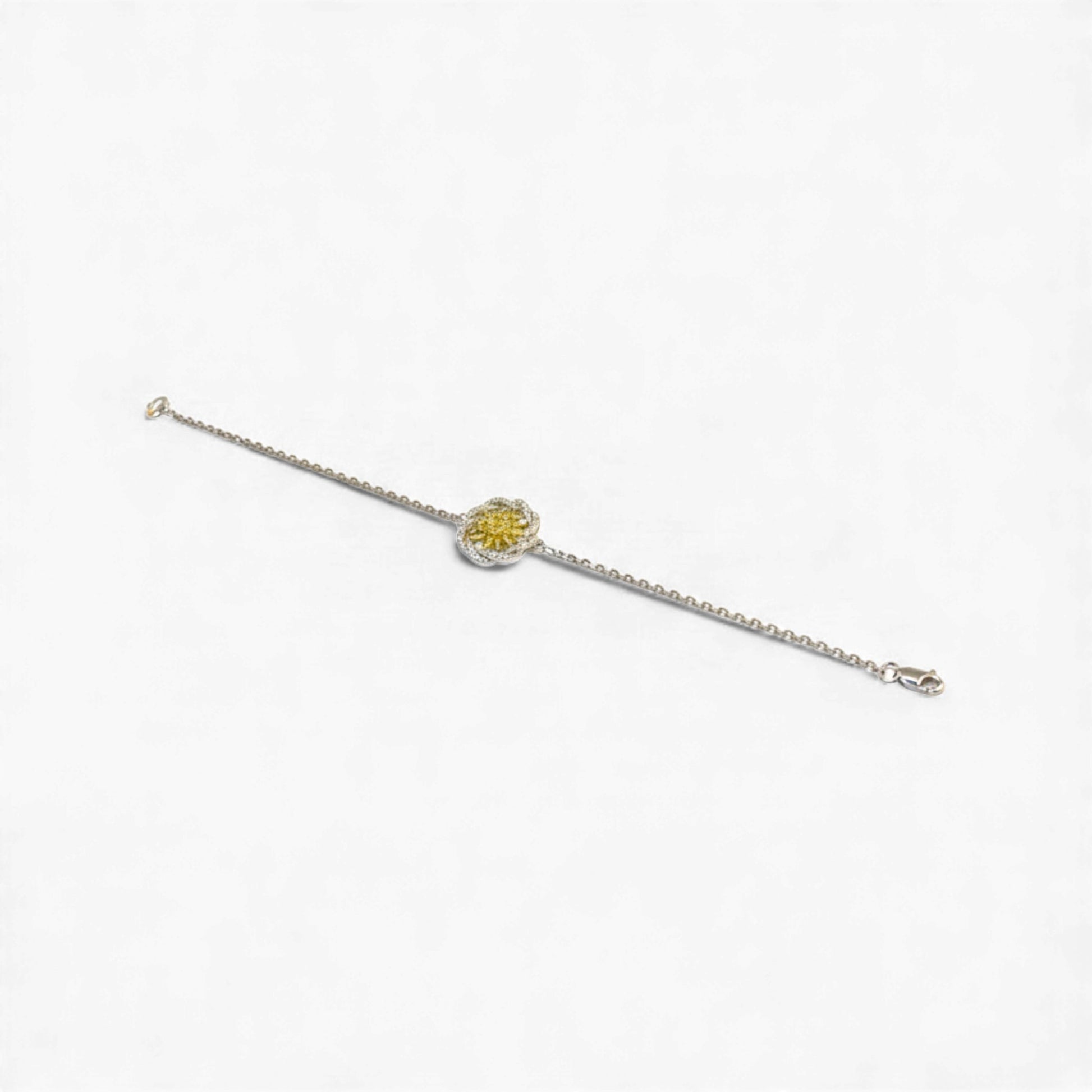 Silver bracelet with a yellow gemstone on a white background