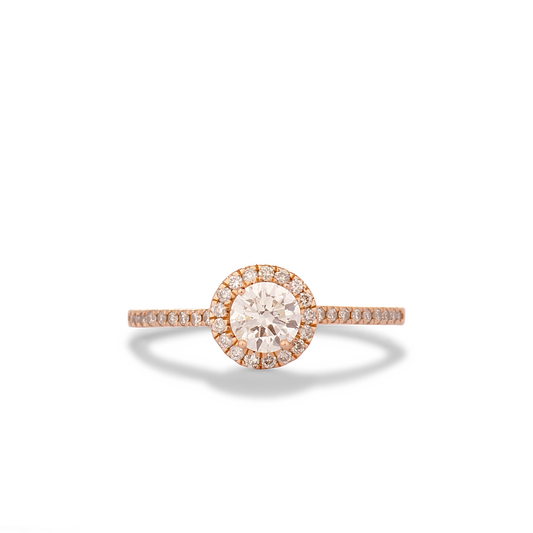 Rose gold ring with a diamond on a white background