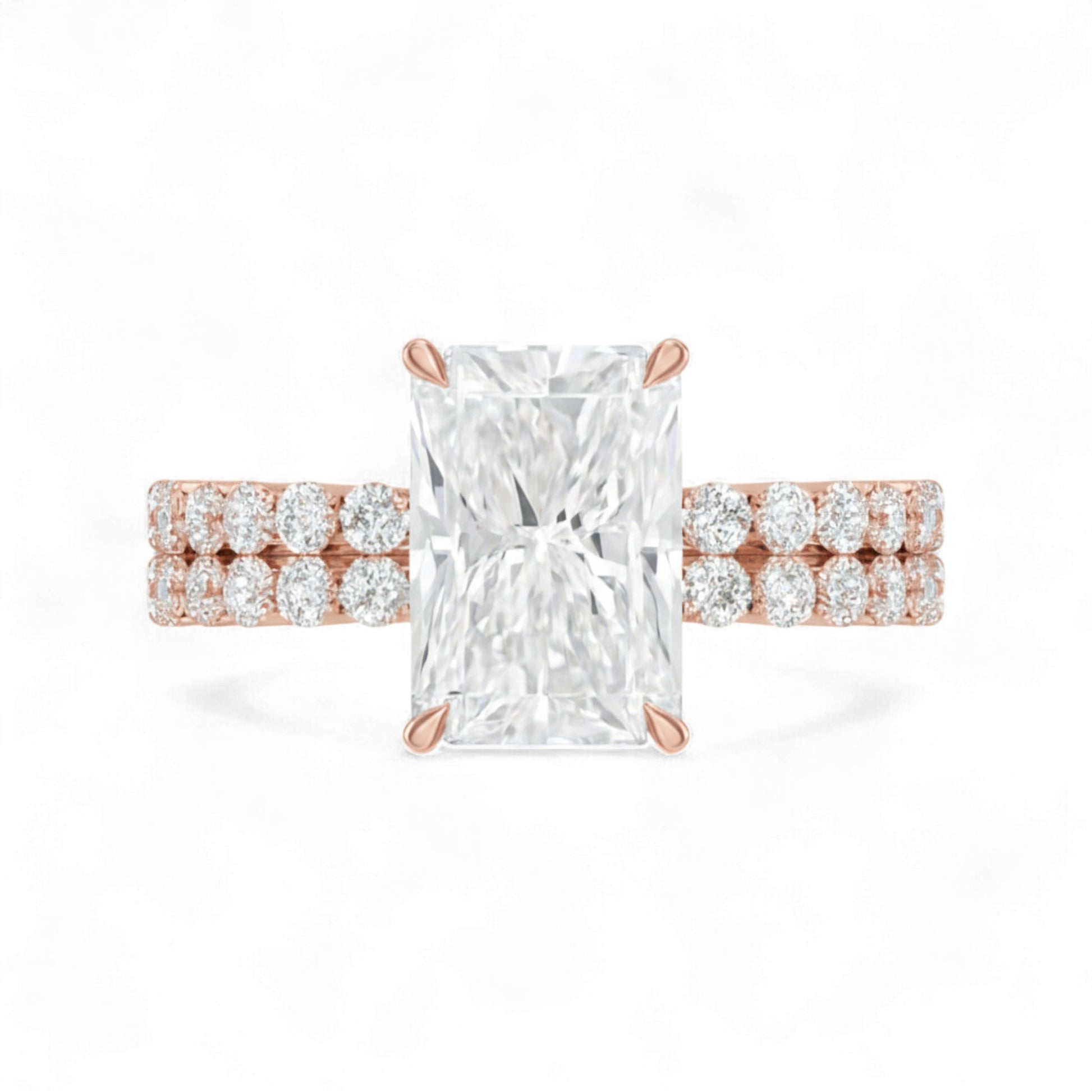 Rose gold ring with a large diamond and smaller diamonds on the band against a white background