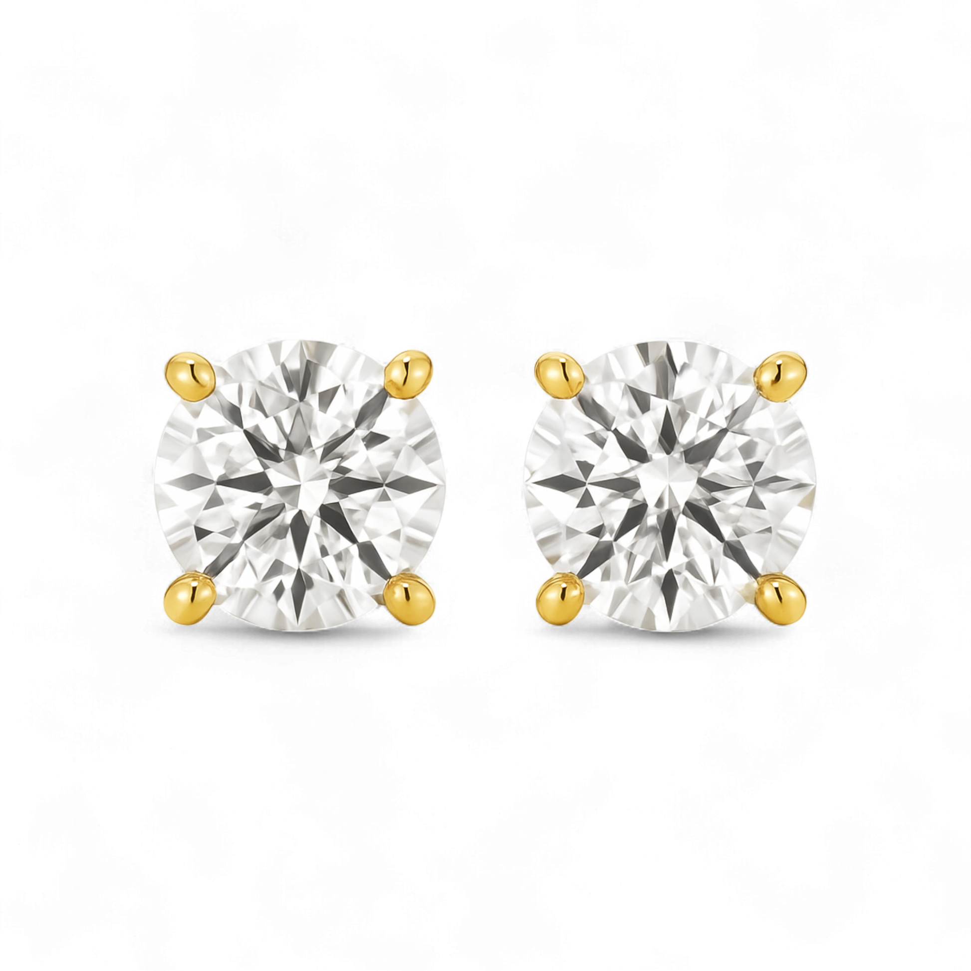 Pair of gold and silver stud earrings on a white background