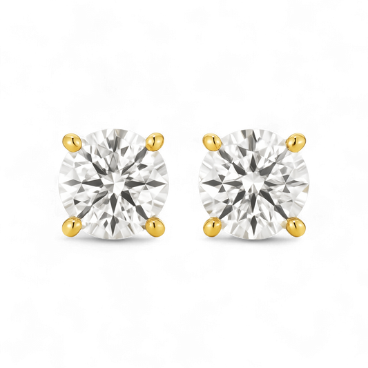 Pair of gold and silver stud earrings on a white background