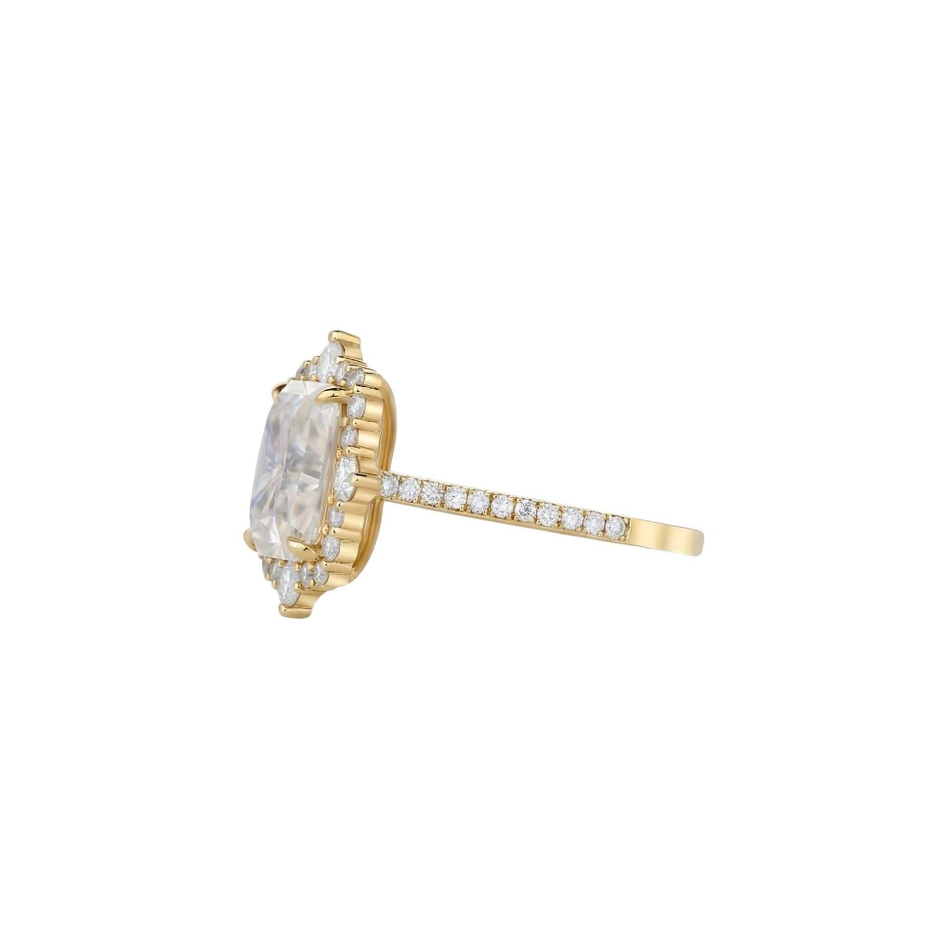 Gold ring with a large marquise-shaped diamond and smaller diamonds on a white background