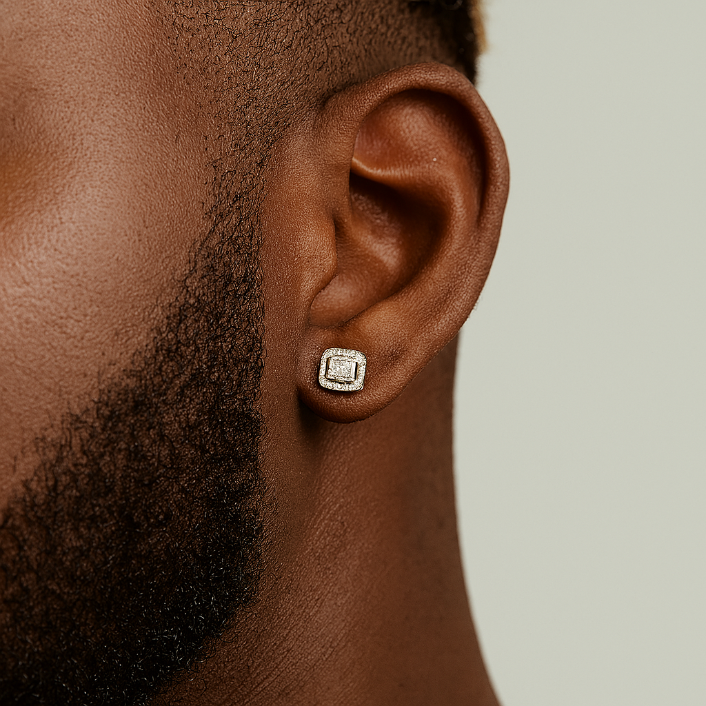 Close-up of an ear wearing a diamond stud earring on a neutral background