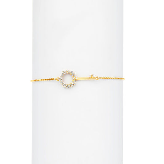 Gold bracelet with a circular design on a white background